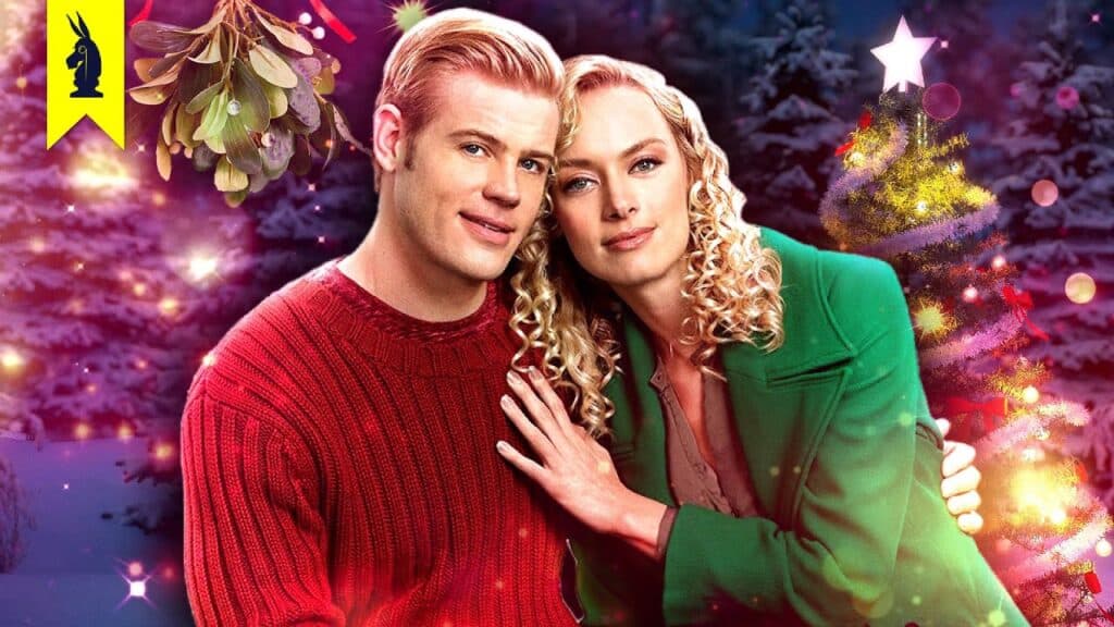 A couple in festive attire poses in front of a decorated Christmas tree, surrounded by holiday lights and mistletoe.