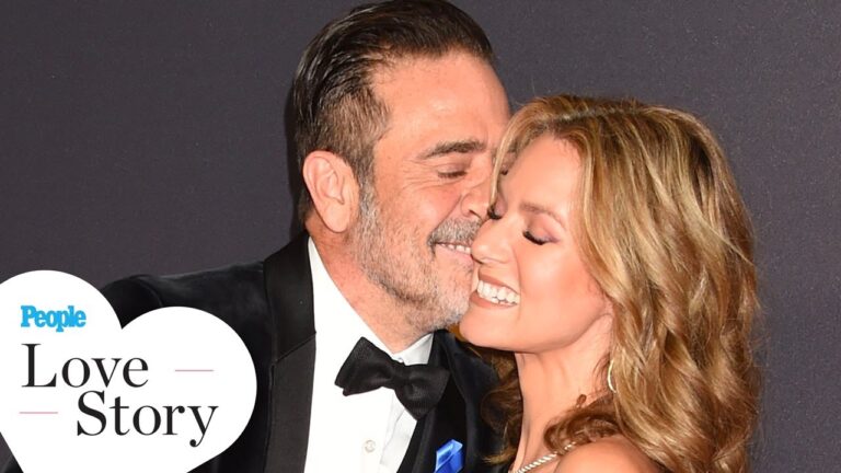 Man and woman smiling and embracing on a red carpet, with text "People Love Story" in a heart shape at the bottom left.