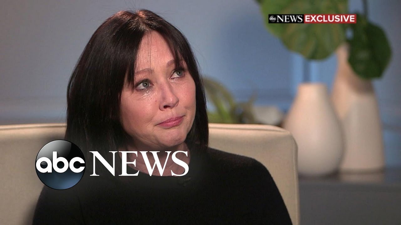 A woman with dark hair is sitting in an interview setting, appearing emotional. The ABC News logo is in the bottom left corner.