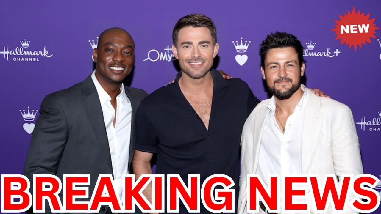 Three men posing together in front of a purple backdrop with logos. "Breaking News" text overlaid at the bottom.